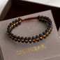 Bracelet en Onyx Mat & Perles Dorées – Tressage artisanal
